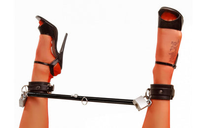 Keep your plaything in place and spread them wide with this darkly sexy spreader bar. Made of durable steel, the bar adjusts between 23 and 35 inches. This black bar has eyebolts securely attached to each end. Wrist and ankle cuffs can be attached to the bar as you desire, making it not only a vital accessory to your bondage play, but a warm welcome to any devious collection.