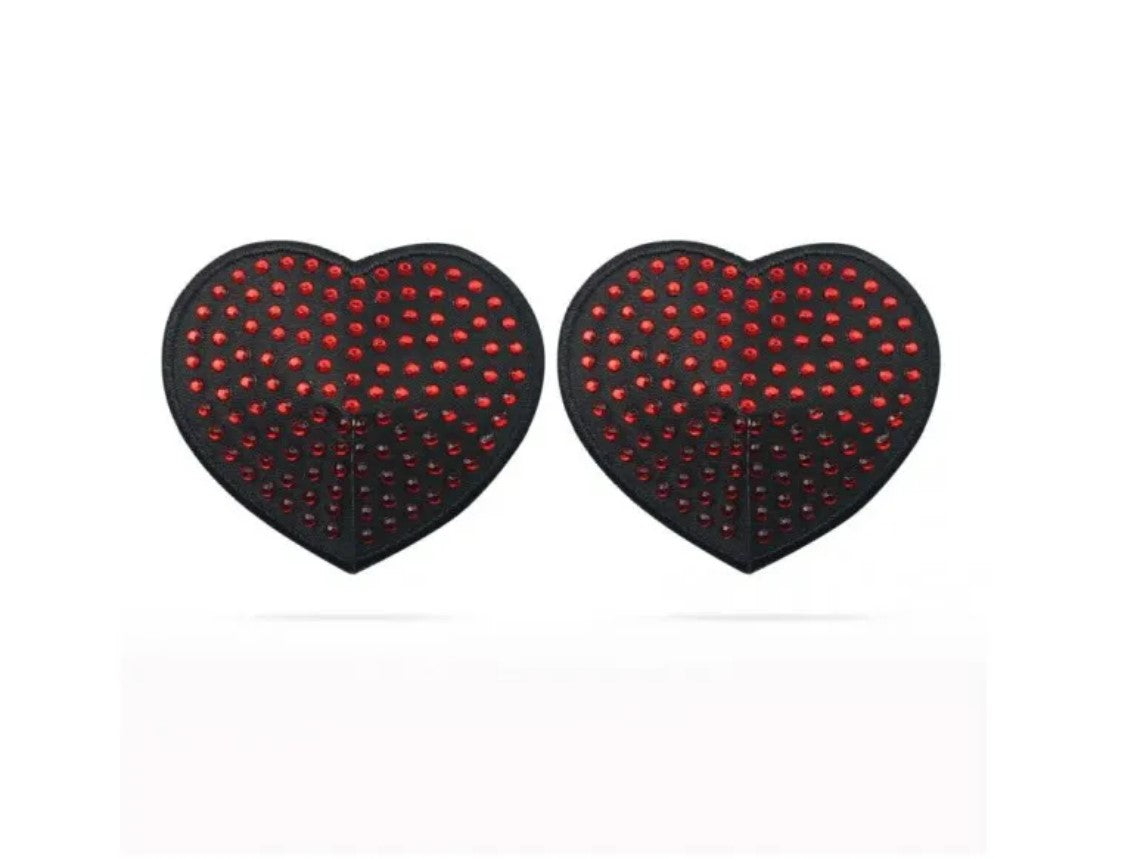 Love Toy | Reusable Red Diamond Heart Nipple Pasties This pair of sultry Black Heart Pasties, adorned with shimmering Ruby Red Gems, comes with an adhesive backing for easy application. Be the temptress you know you are and draw them in. To reuse, simply wash with soap and water, then lay on a flat surface with the adhesive side up to dry. 