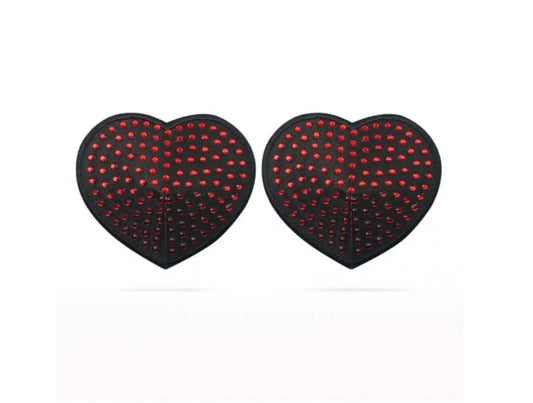 Love Toy | Reusable Red Diamond Heart Nipple Pasties This pair of sultry Black Heart Pasties, adorned with shimmering Ruby Red Gems, comes with an adhesive backing for easy application. Be the temptress you know you are and draw them in. To reuse, simply wash with soap and water, then lay on a flat surface with the adhesive side up to dry. 